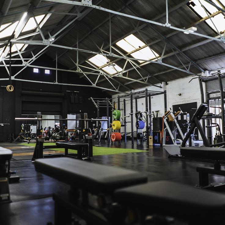 Interior of a professional gym with weight training equipment and mirrors